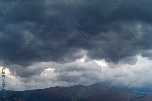 Gray sky with storm clouds over the mountains