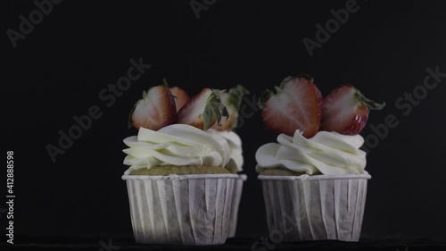Three cupcakes decorated with delicious strawberries. Delicious cupcakes.