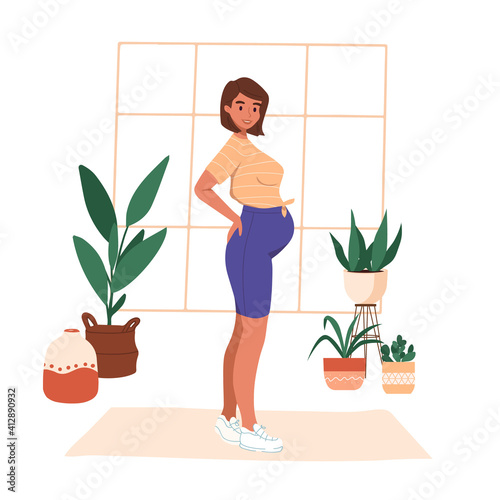 Young pregnant woman in sportswear doing yoga at home. Prenatal sport exercise, aerobic activity. Trendy scandinavian hygge interior, living room. Happy motherhood healthy lifestyle