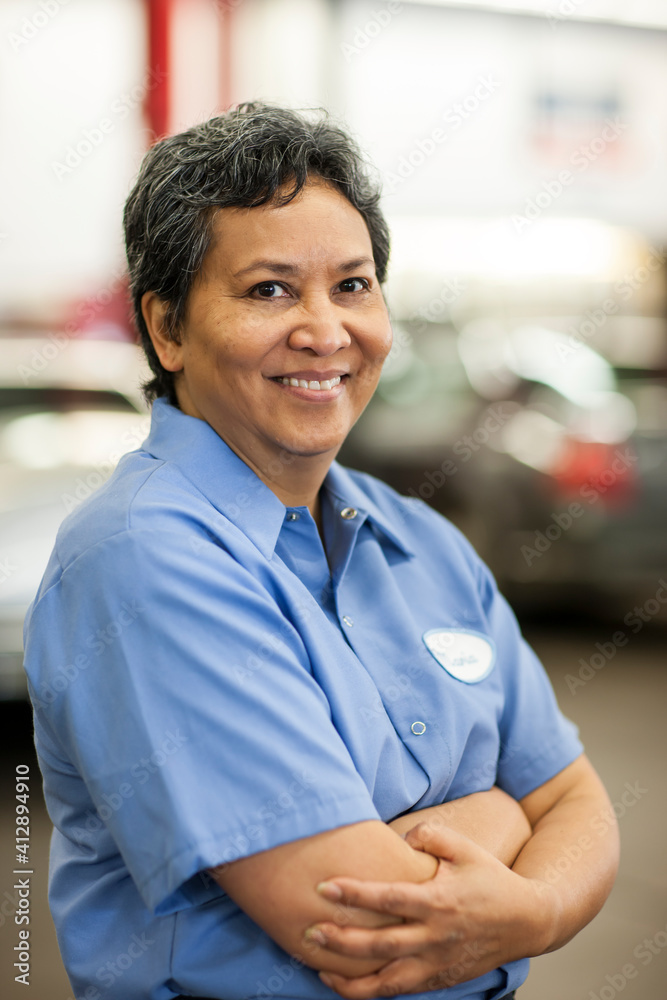Portrait of female hispanic mechanic in auto repair shop Portrait of female hispanic mechanic in auto repair shop