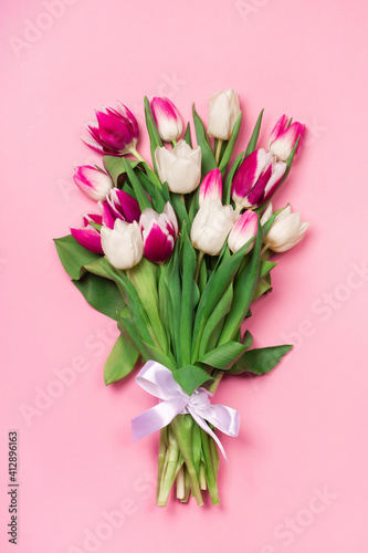 Bouquet of tulips in pink and white colors. Concept of spring, Women's Day, Mother's Day, 8 March, the holiday greetings. Copy space, flat lay. © elena_fedorina