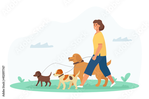 A dog walker, a young pretty woman enjoys the activity in the park with her pets. Pet Care Service.