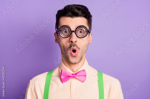 Photo of astonished amazed shocked man wear geek glasses information reaction isolated on purple color background