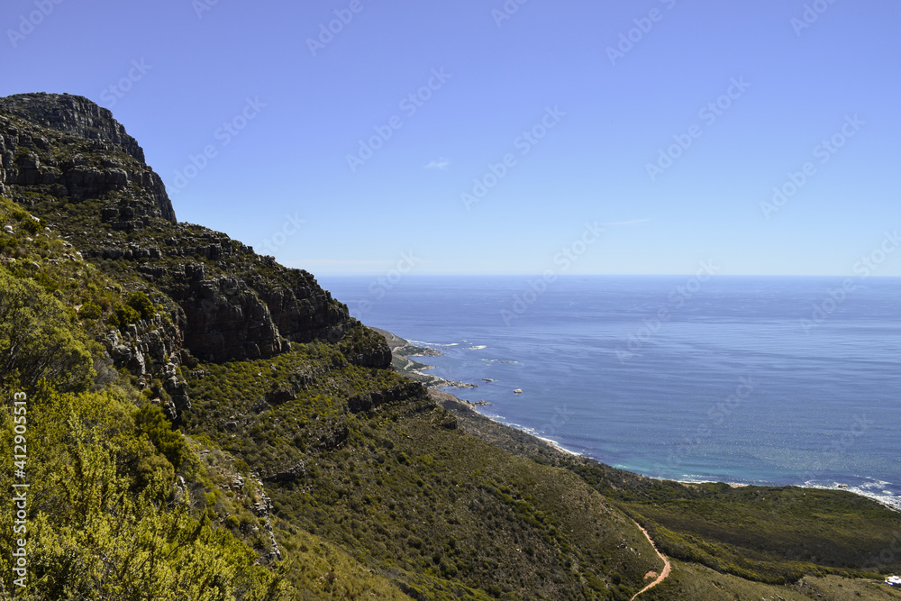 View of the mountain and the sea from the slopes of Table Mountain in Kasteelspoort hike. Cape Town, South Africa.