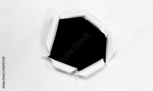 Ripped hole paper isolated on black background