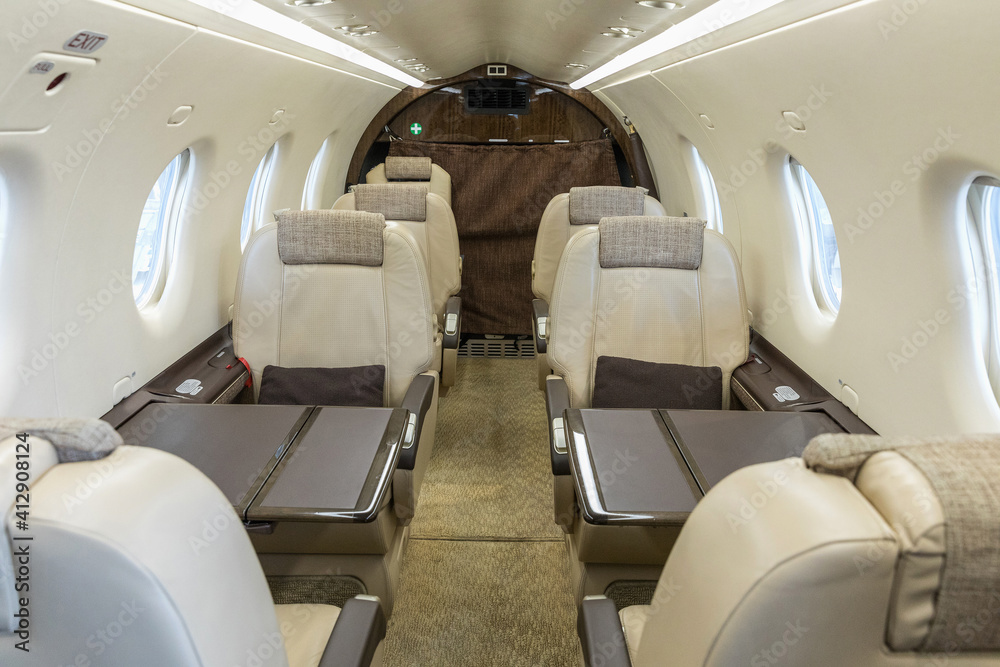 Luxury bright leather interior of a modern commercial airplane. Inside of a small business turboprop aircraft.