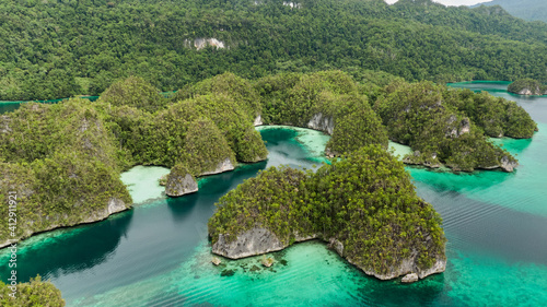 Aerial View Of Triton Bay In Raja Ampat Islands: Lagoon With Turquoise Water And Green Tropical Trees. Wide Angle Nature: Pacific Ocean And Beautiful Landscape In Papua, Indonesia. photo