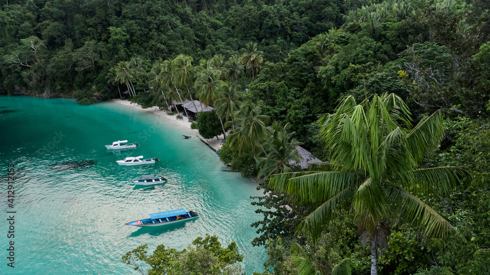 Lagoon With Boats Near Ocean Beach With Huts Among Palm Trees In Kaimana Island, Raja Ampat. Stunning View From Drone On Water Transport In Turquoise Sea Near Tropical Resort In Papua, Indonesia.