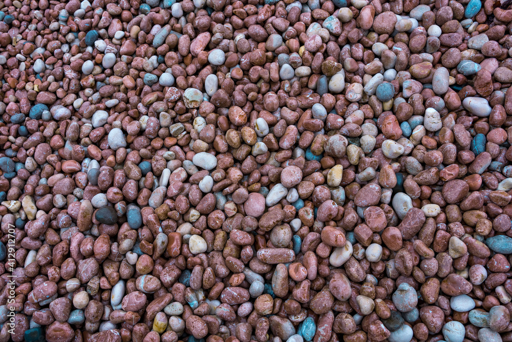 Natural beach pebbles on the beach as a natural background