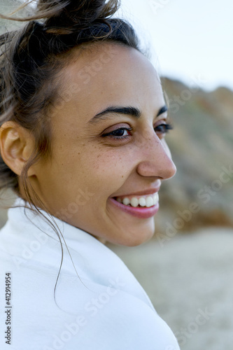 Authentic portrait close-up face latin woman looking away with smile, feeling good and calm. photo