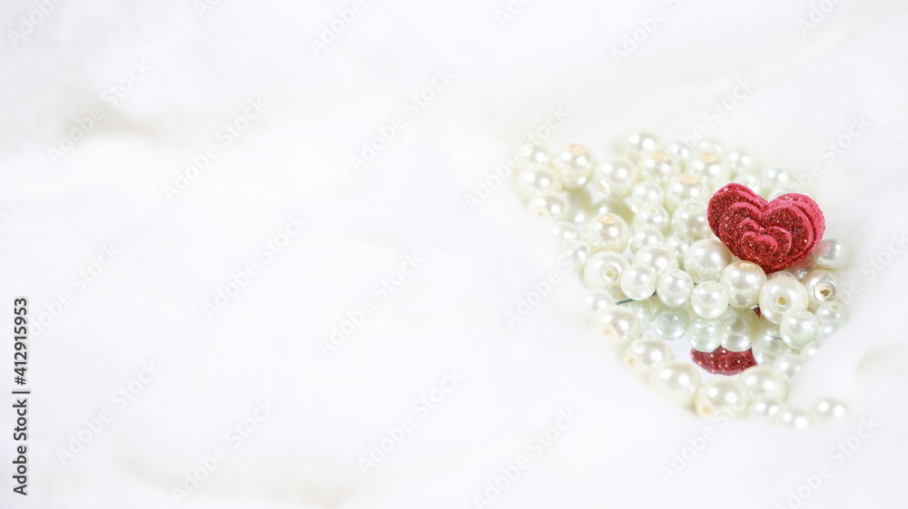 Red valentine heart reflected in a mirror with white pearls on both sides with white background for writing text,OR banner. Red valentine heart reflected in a mirror with white pearls on both sides with white background for writing text,OR banner.