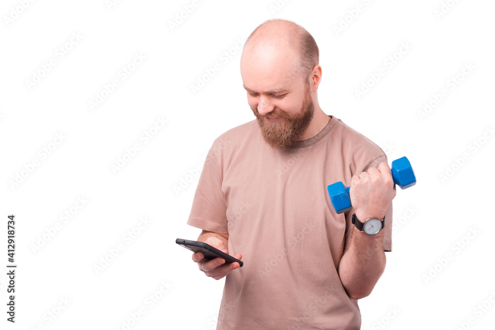Photo of cheerful office worker man using smartphone and working with blue dumbbell. Photo of cheerful office worker man using smartphone and working with blue dumbbell.