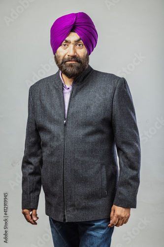 Studio portrait of a Sikh handsome man looking at camera with smile photo