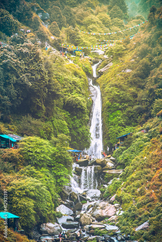 Majestic landscape of Bhagsu Nag waterfall and green forest around at Mcleodganj, Himachal Pradesh, India.