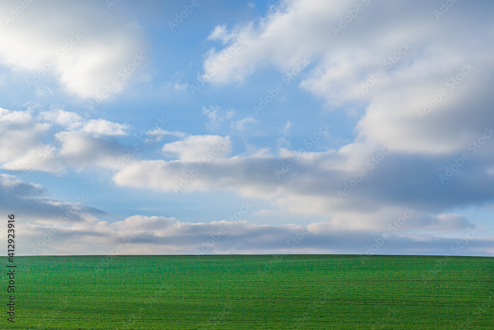 scenic landscape with green field and sblue sky with soft clouds as background scenic landscape with green field and sblue sky with soft clouds as background