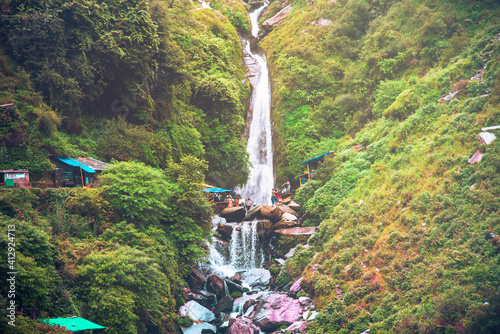Majestic landscape of Bhagsu Nag waterfall and green forest around at Mcleodganj, Himachal Pradesh, India.