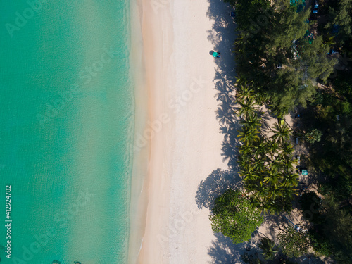 Aerial view of drone. Top view of seawater wave in nature on sandy beach. In sunset time. Summer beach sea sunset. Nature and travel concept.