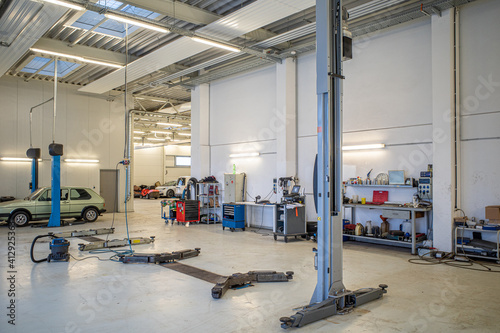 in big empty car workshop there are some car lifts