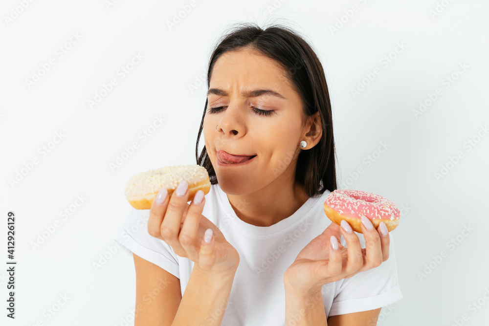Young beautiful woman wants to eat donuts Young beautiful woman wants to eat donuts