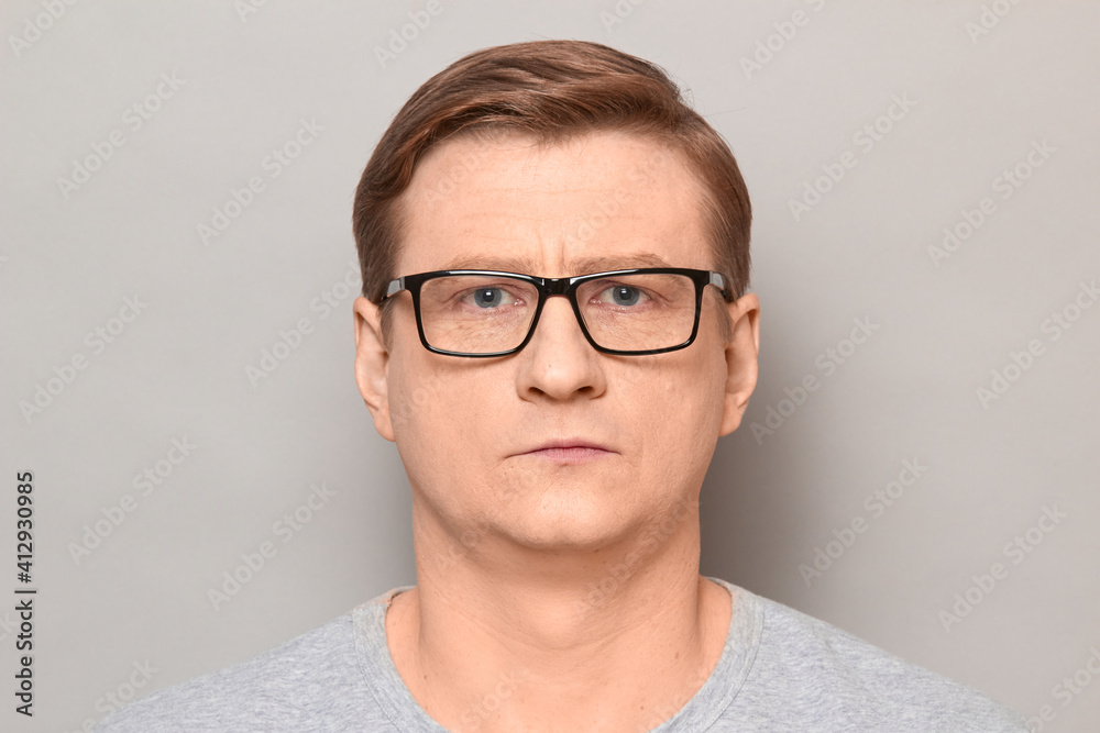 Portrait of mature man with glasses with serious expression on face Portrait of mature man with glasses with serious expression on face