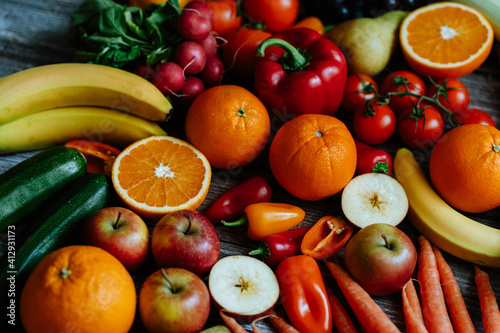 Fresh  healthy  colorful composition from various raw  seasonal fruits and vegetables  food still life on a wooden background