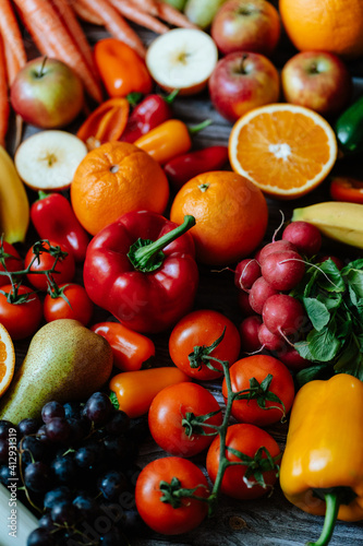 Fresh  healthy  colorful composition from various raw  seasonal fruits and vegetables  food still life on a wooden background