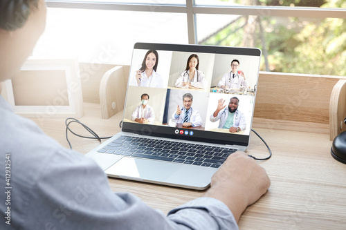 Close-ups on the computer screens a group of doctors greets the patients via online video calls. Concept of medical service. Consult a sick person online During the coronavirus spread