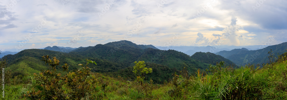 Panorama photo of Sunset or evening time over clouds with mountain hill forest 