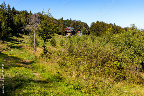 Fototapeta Naklejka Na Ścianę i Meble -  Panorama of Przelecz Midowicza Pass below Leskowiec peak with Schronisko na Leskowcu tourist mountain hut in Little Beskids mountains near Andrychow in Lesser Poland