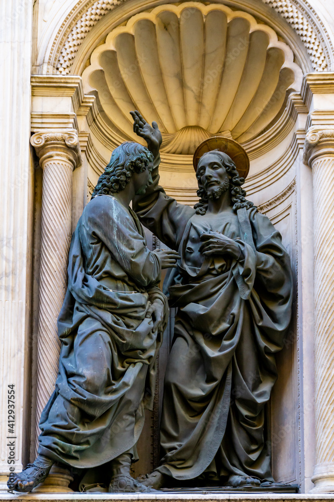 Fototapeta premium Christ and St. Thomas statues by Andrea del Verrocchio, at Orsanmichele church exterior in Florence, Italy