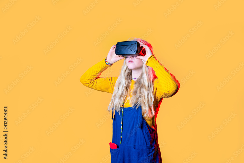 Caucasian woman on green background using vr glasses - Isolated caucasian young woman wearing futuristic headset astonished