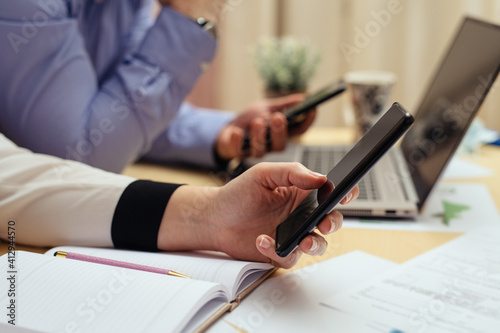 Woman with bills and smart phone at the table