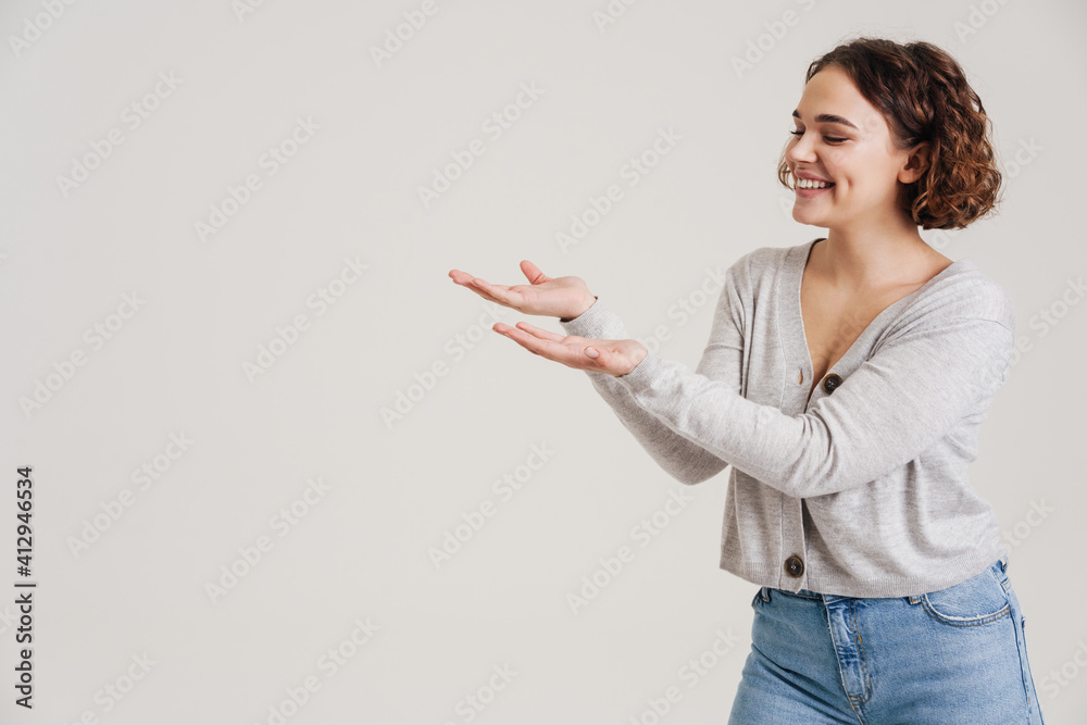 Happy smiling beautiful young woman presenting Happy smiling beautiful young woman presenting