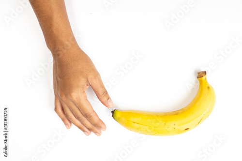 Banana peel aging in hand isolated on white background.