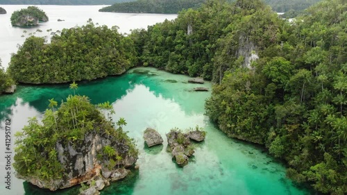 Triton Bay With Turquoise Sea And Green Tropical Trees In Kaimana Islands. Aerial View Of Wide Angle Nature; Pacific Lagoon And Beautiful Landscape In Papua, Indonesia. photo