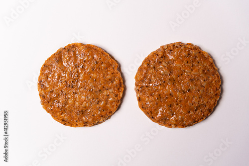 two raw vegan burger on white background. veggie hamburger with copy space