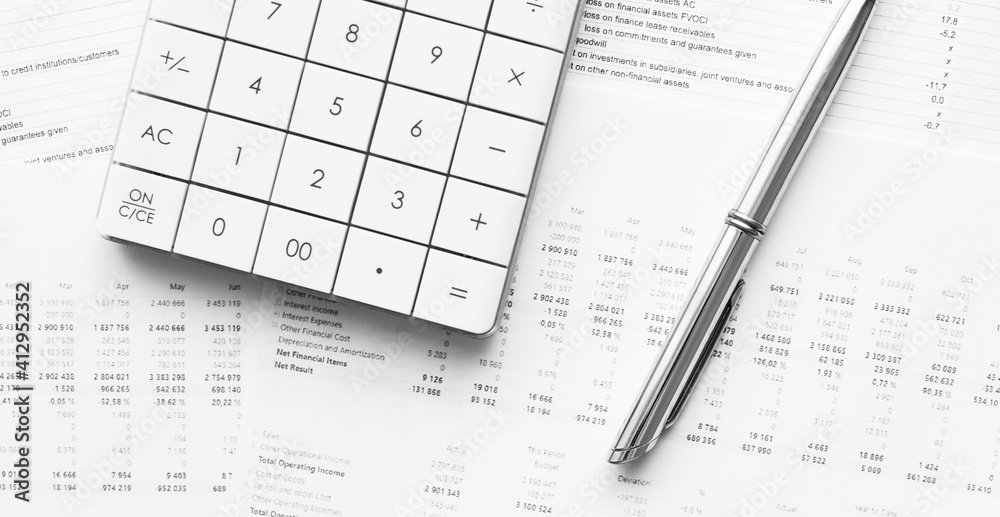Calculator with pen on financial data. Business and financial research concept. Calculator with pen on financial data. Business and financial research concept.