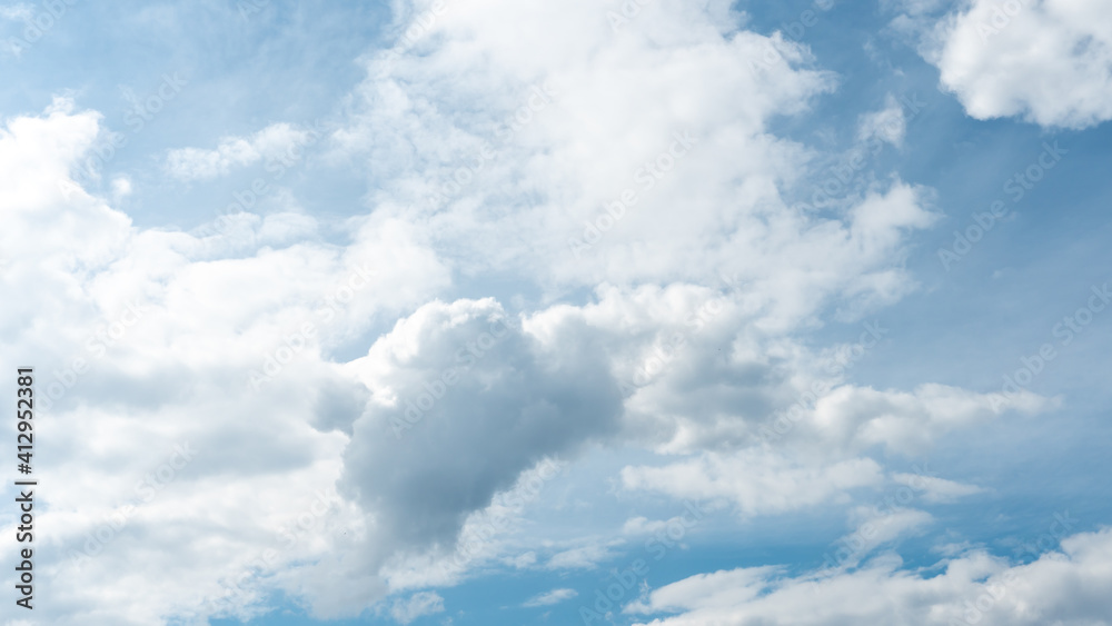 Beautiful fluffy clouds in the evening sky. The sunlight gives a side light on the clouds. Clouds before rain. Beautiful fluffy clouds in the evening sky. The sunlight gives a side light on the clouds. Clouds before rain.