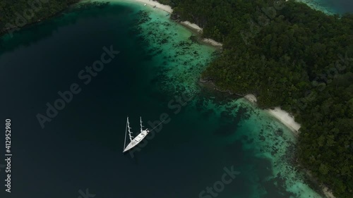 Triton Bay: Boat On Turquoise Sea And Green Tropical Trees In Kaimana Islands. Aerial View Of Wide Angle Nature; Pacific Ocean And Picturesque Landscape In Papua, Indonesia. photo