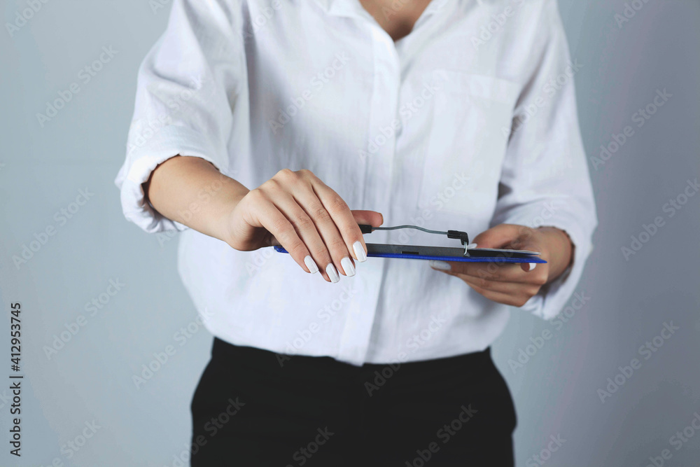 Young business Woman holds a blue folder.