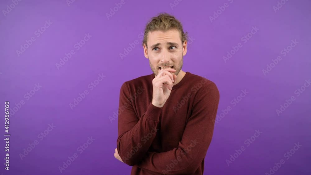 young european man in burgundy sweater emotionally rejoices at success 4K