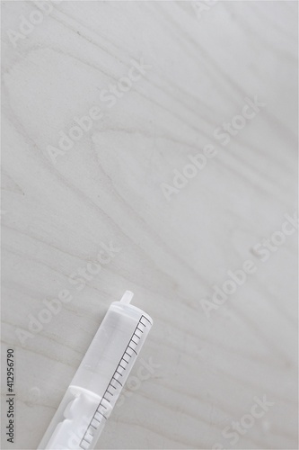 Isolated medical syringe on wooden background for emergency medical cure of sick patients surgery by doctor at hospital and clinic injection vaccine medication liquid disposable place for text