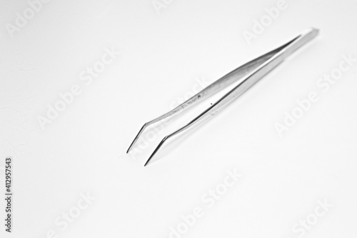 Isolated medical tweezers on white background for medical examination of sick patients surgery by doctor at hospital and clinic dental hygiene at dentist disposable accessory medical tool copyspace