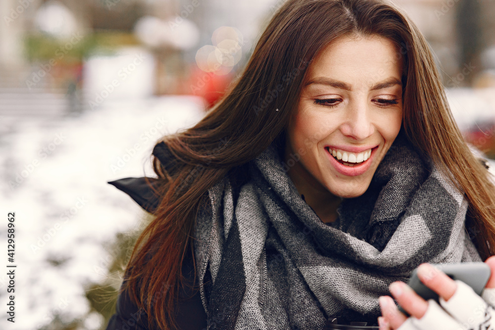 Close-up portrait of woman in black jacket. Woman standing on the street in snowy day. Close-up portrait of woman in black jacket. Woman standing on the street in snowy day.