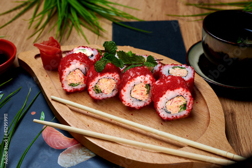 japanese rolls, sushi with sauce on a wooden table