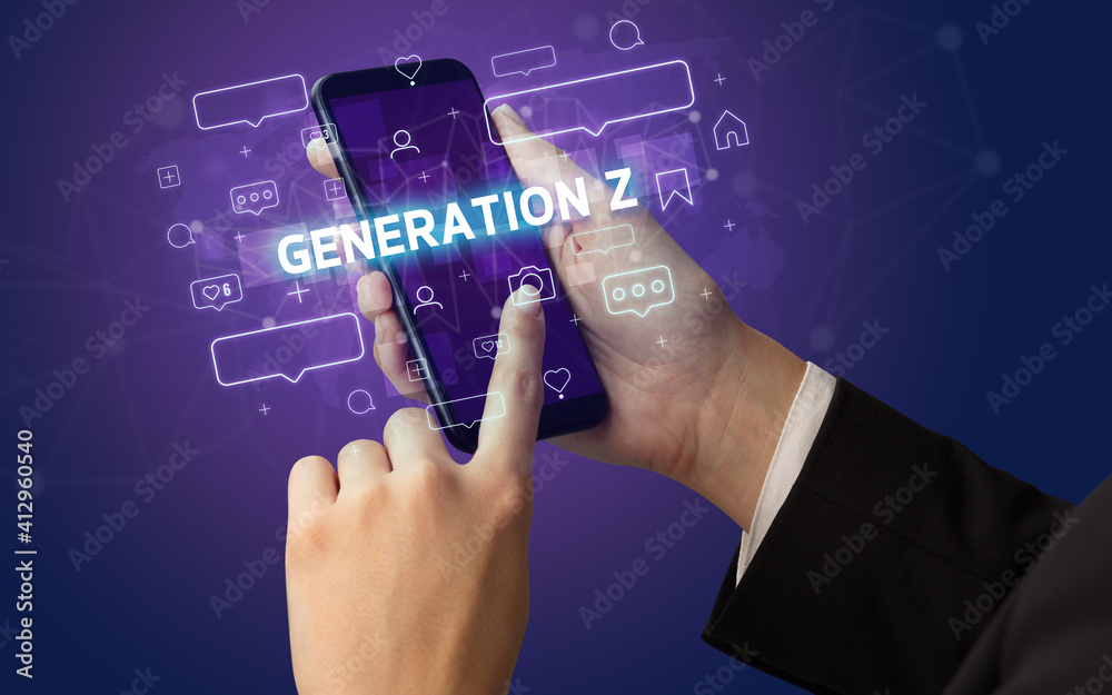 Female hand typing on smartphone with GENERATION Z inscription, social media concept Female hand typing on smartphone with GENERATION Z inscription, social media concept
