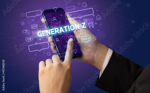 Female hand typing on smartphone with GENERATION Z inscription, social media concept