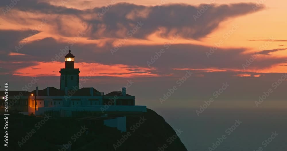 Farol do Cabo da Roca lighthouseon cliff of atlantic ocean, Portugal, Europe. Aerial view of colorful sunset sky over lighthouse, 4k footage Farol do Cabo da Roca lighthouseon cliff of atlantic ocean, Portugal, Europe. Aerial view of colorful sunset sky over lighthouse, 4k footage