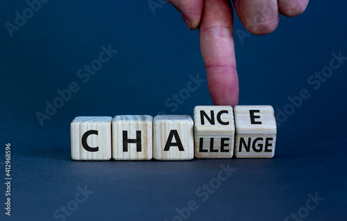 Challenge or chance symbol. Businessman turns cubes and changes the word 'challenge' to 'chance'. Beautiful grey background, copy space. Business and challenge or chance concept.
