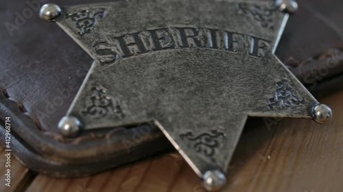 Old west Sheriff badge macro close up on a leather wallet - police in the old west of America photo